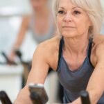 Woman over 50 doing cardio at the gym, the workout that started the conversation about creatine for women over 50