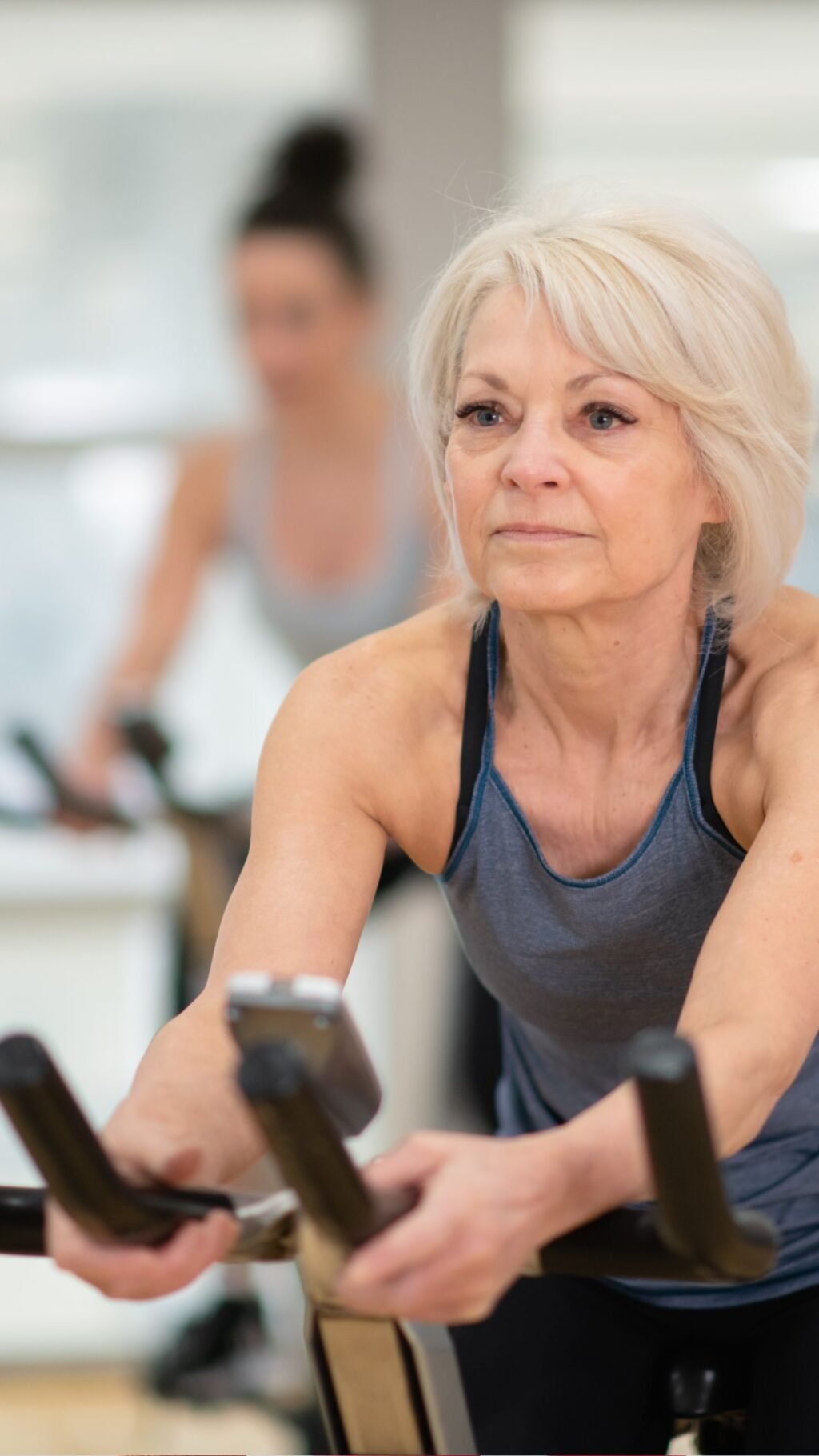 Woman over 50 doing cardio at the gym, the workout that started the conversation about creatine for women over 50