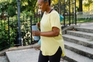 Woman over 50 walking outdoors, supporting heart health and cholesterol after menopause